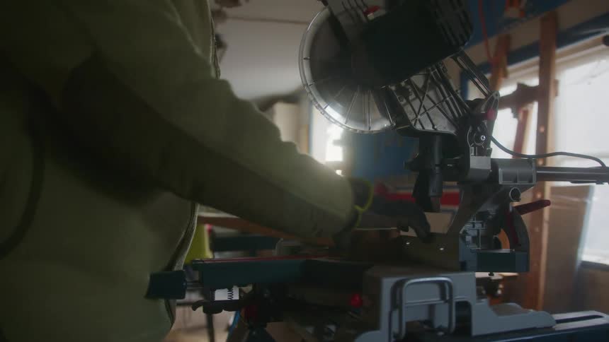 A person cutting wood with a saw