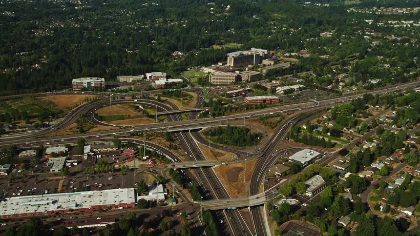 A sunny aerial view of a highway with multiple interchanges in Southwest Portland Oregon approaching the Providence St Vincent Medical Center
