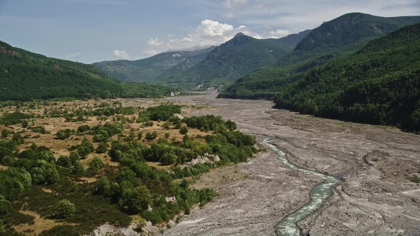 Aerial footage of low flight over North Fork Toutle River approaching Mount St Helens in Washington showcasing the natural beauty of the mountains rivers and landscape