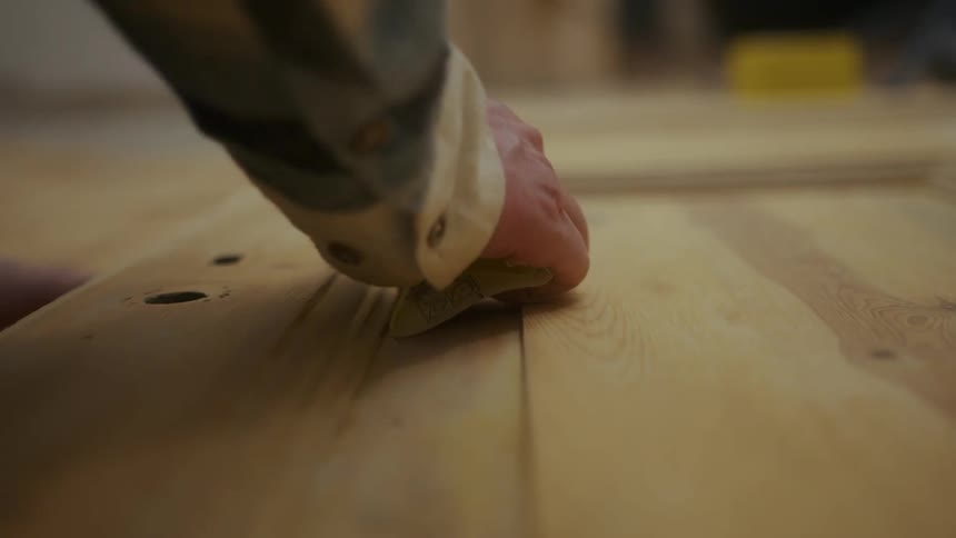 Man working on a piece of wood indoor