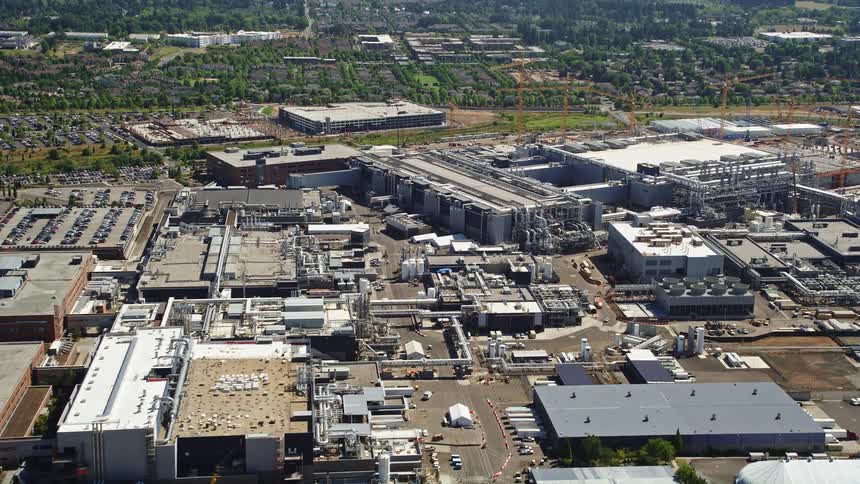 Aerial footage of approaching Intel Ronler Acres campus in Hillsboro Oregon during a sunny day showcasing the semiconductor manufacturing plant and its surroundings
