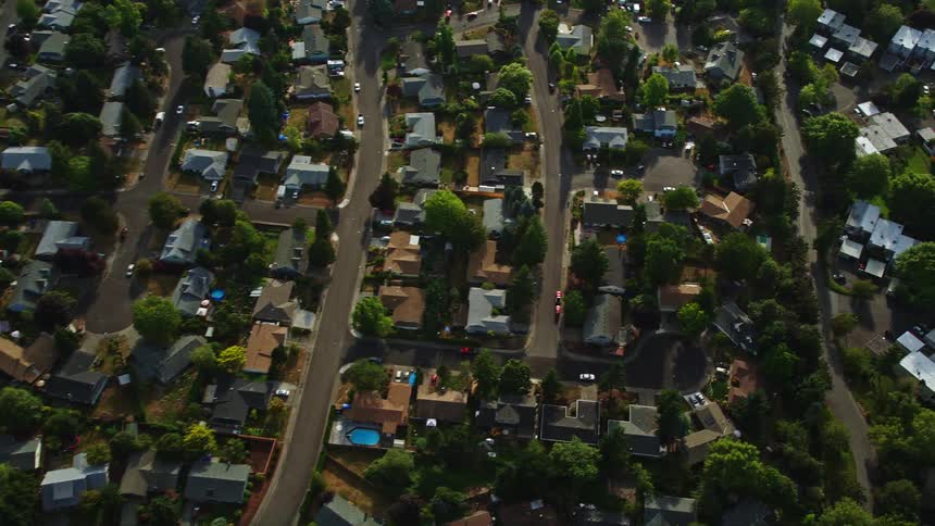 Aerial view of Beaverton Oregon showcasing a suburban community with tract homes tiny condo units and residential houses during the day