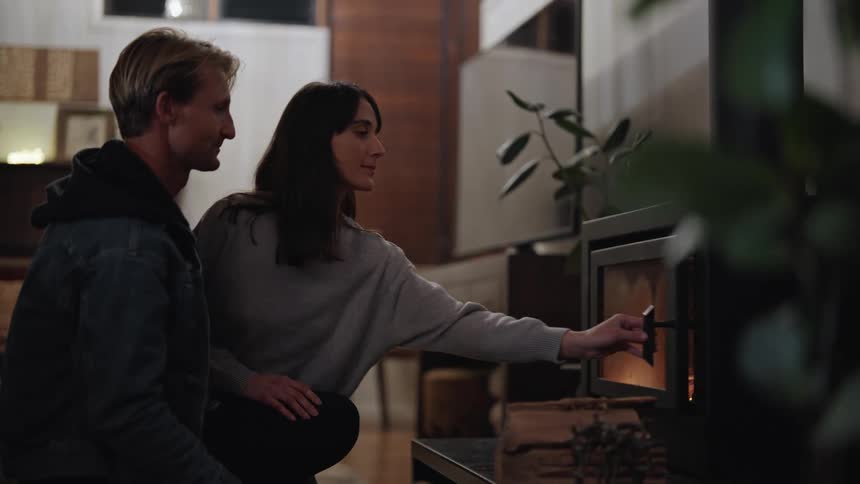 A man and a woman add fuel to the fire as they talk