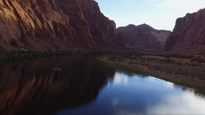 View of a body of water before some cliffs on a sunny day