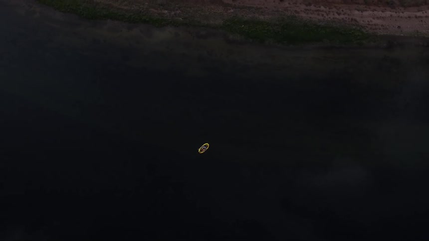 Small boat in large lake