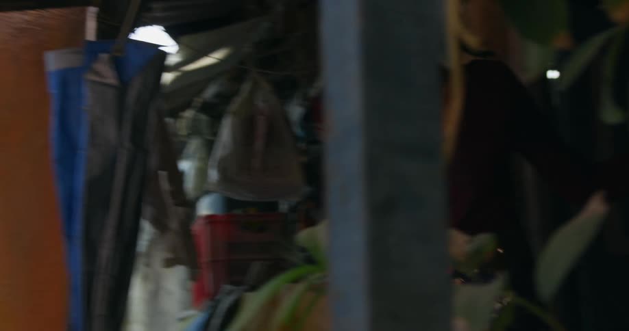 A woman looks around after walking out of her house