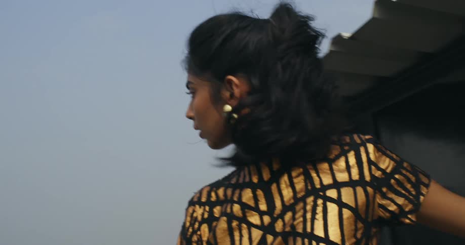 A woman exits her home