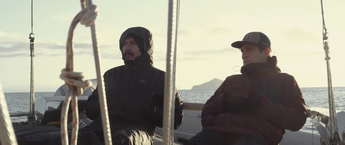 Two men relaxing and talking on a boat