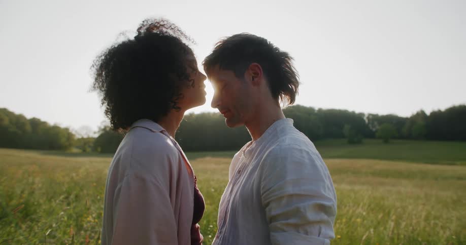 A woman kisses a man on the field