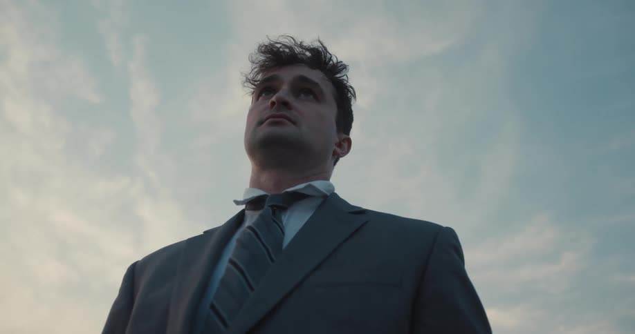 A businessman in a suit with a pensive expression