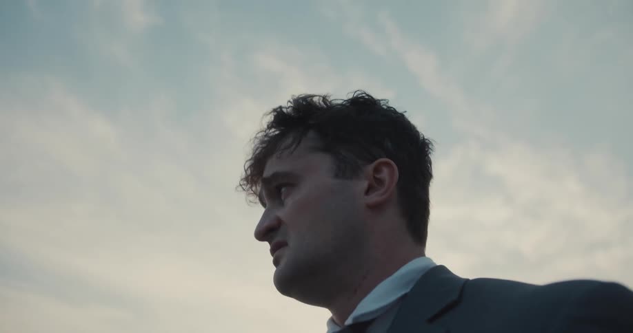 A disheveled businessman in distress
