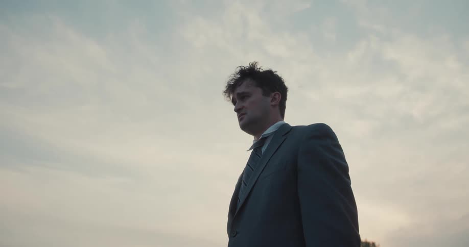 A businessman in a suit with a look of worry and sadness