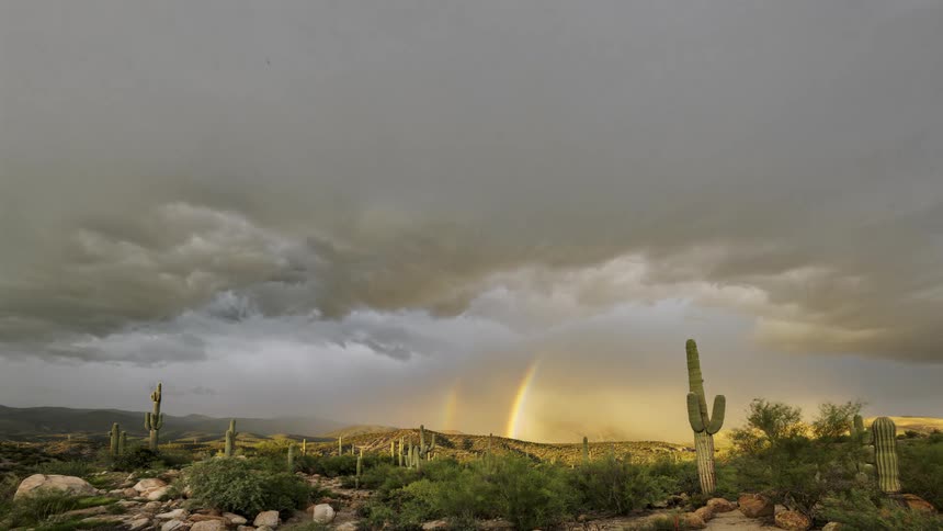 A rainbow in the cloudy sky during sunset