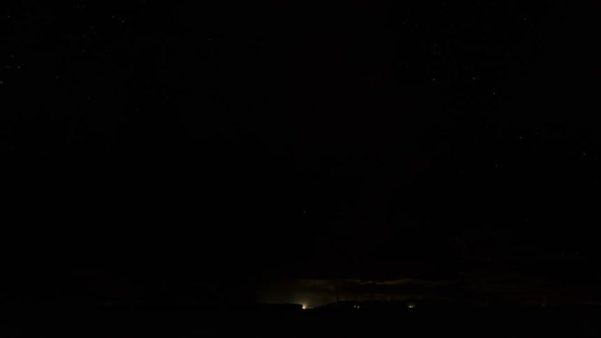 Thunderstorm over a road in the desert at night