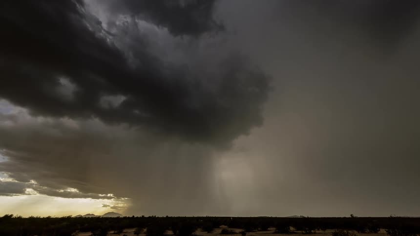 Storm clouds pour rain and shoot lightning as they pass
