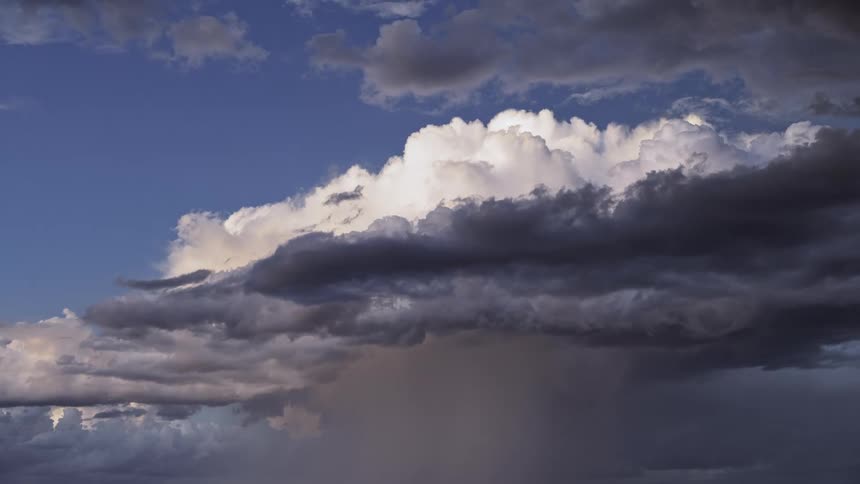 Dark and white clouds float in the sky