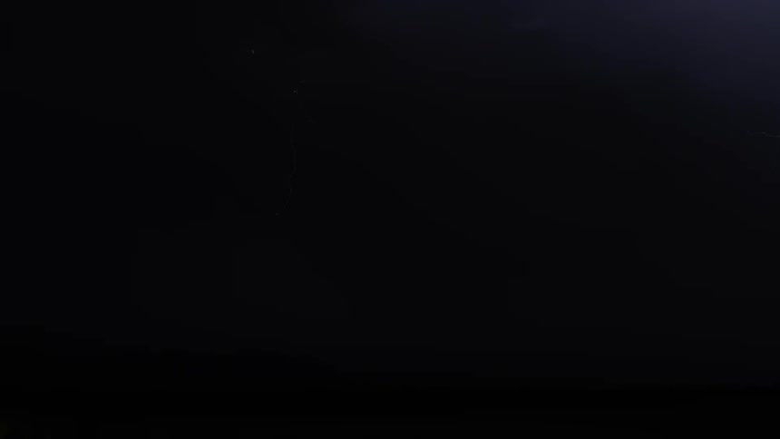 Lightning from a thunderstorm strikes on the desert at night