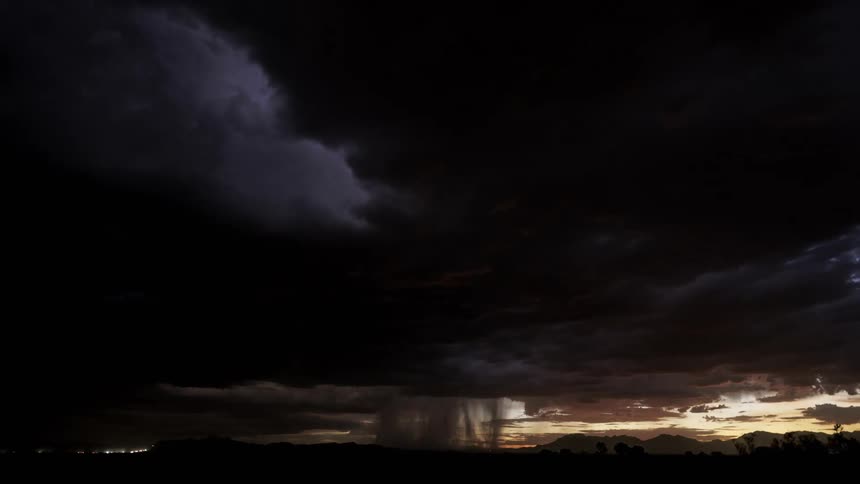 A big thunderstorm with lightning and black clouds during dusk