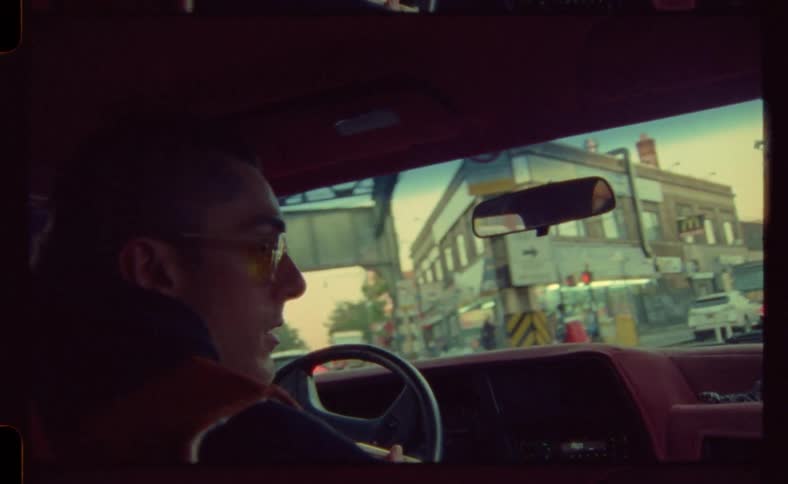 Man drives a car on the city streets at daytime