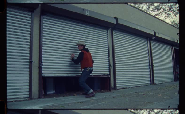 Man opens door on storage space at storage facility