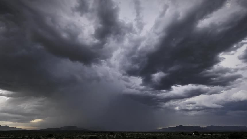 A huge storm cloud with strong winds and lightning crashing to the ground