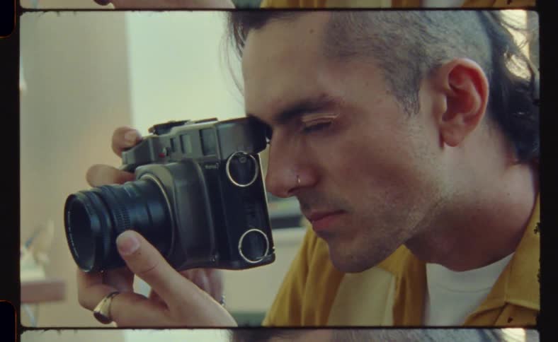 Man adjusting his photographic camera