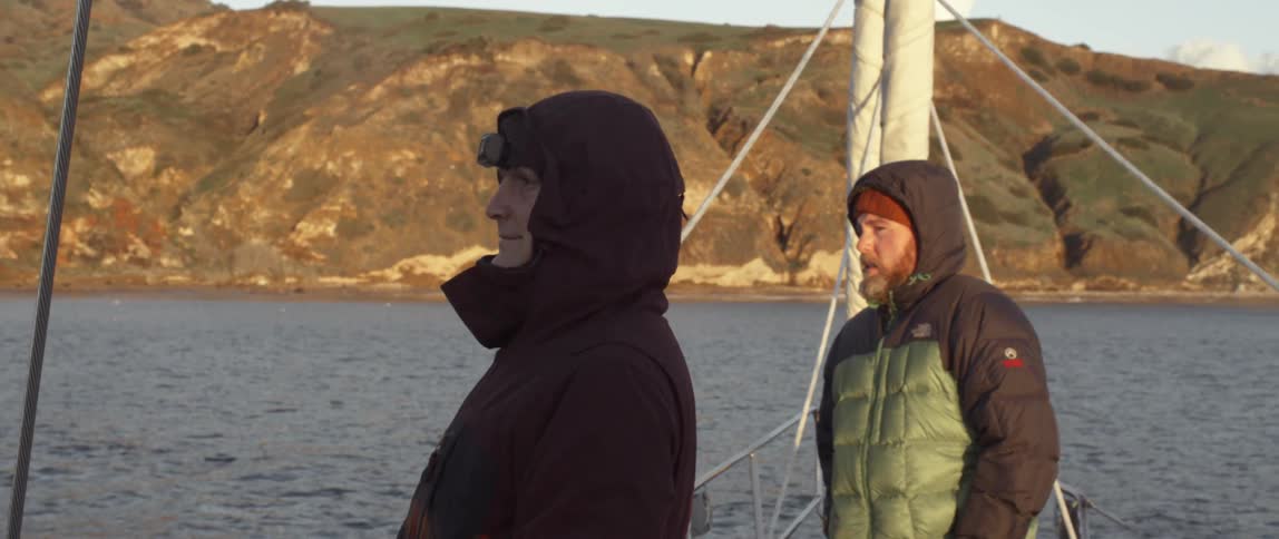 Two men look around on boats