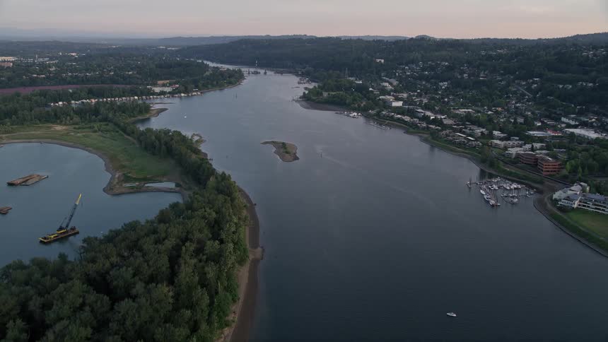 Aerial footage of Willamette River by Ross Island during sunset approaching Toe Island in Portland Oregon