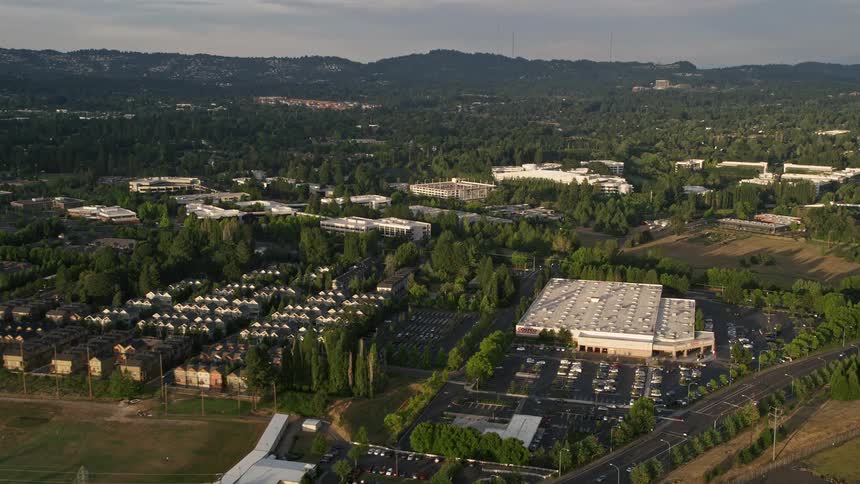 Aerial footage of flying by Costco and approaching Nike Headquarters in Beaverton Oregon during sunset