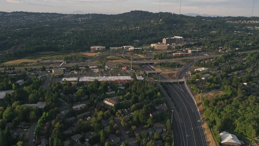 Aerial footage of the Providence St Vincent Medical Center and highway interchange in Southwest Portland Oregon during a beautiful sunset