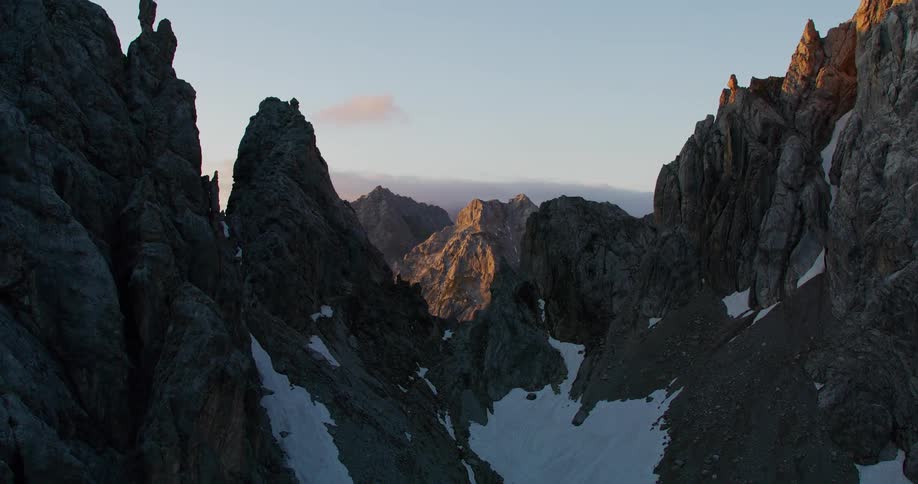 A mountain with rough terrain partly covered in snow