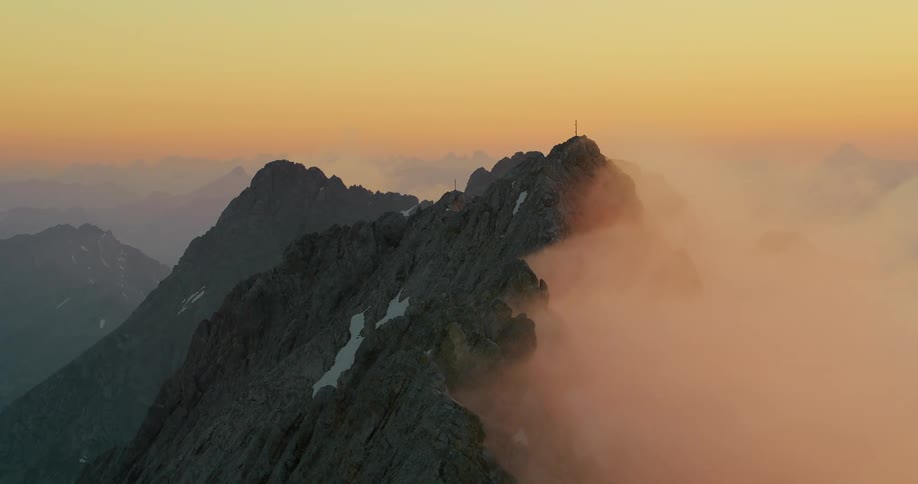 Dawn of the day in the midst of mountains covered with a little snow
