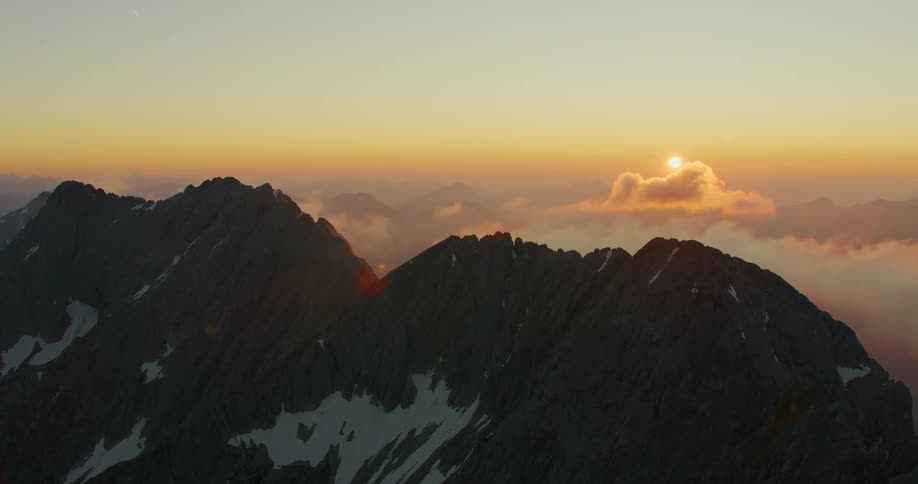 Aerial of a snowy mountain during dawn