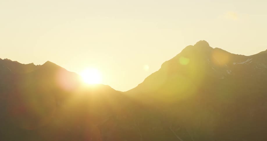 A time lapse of the sun shows it rising above a mountain range