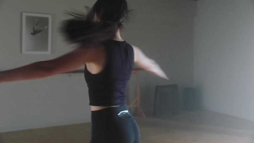 Young woman dancing and spinning her body in ballet movements