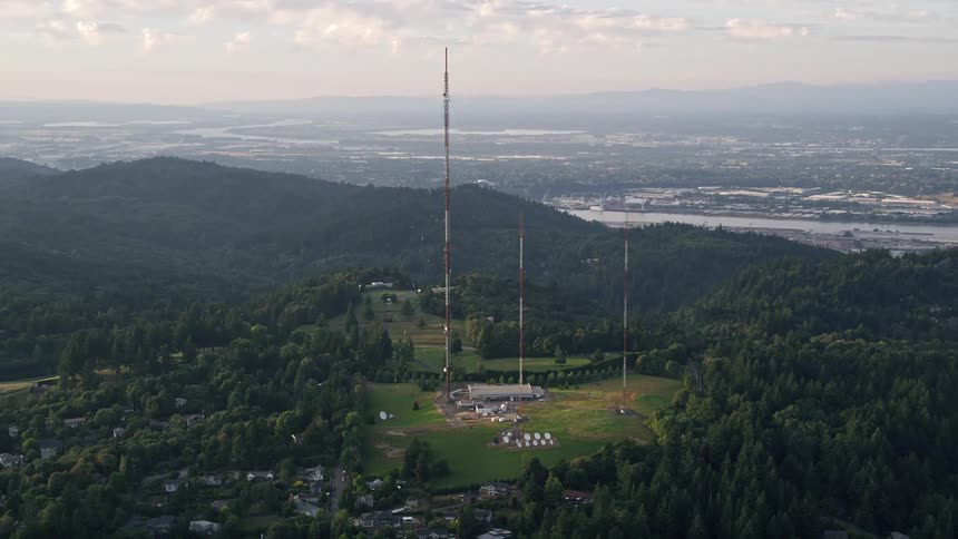  aerial footage capturing the breathtaking view of hilltop radio towers during sunset in Southwest Portland Oregon providing a unique perspective of the scientific facilities and radio transmission towers in the Pacific Northwest