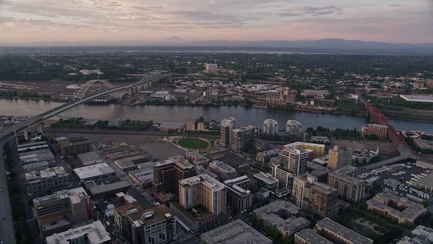 Aerial view of the Fremont Bridge at sunset approaching from Downtown Portland Oregon with the Willamette River flowing underneath