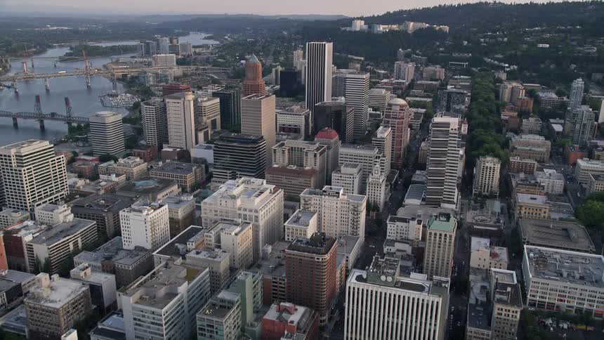 Approaching Oregon Science and Health University at sunset with downtown Portland's high rise buildings in the background