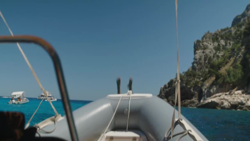 Young adult jumping from inside the boat into the sea