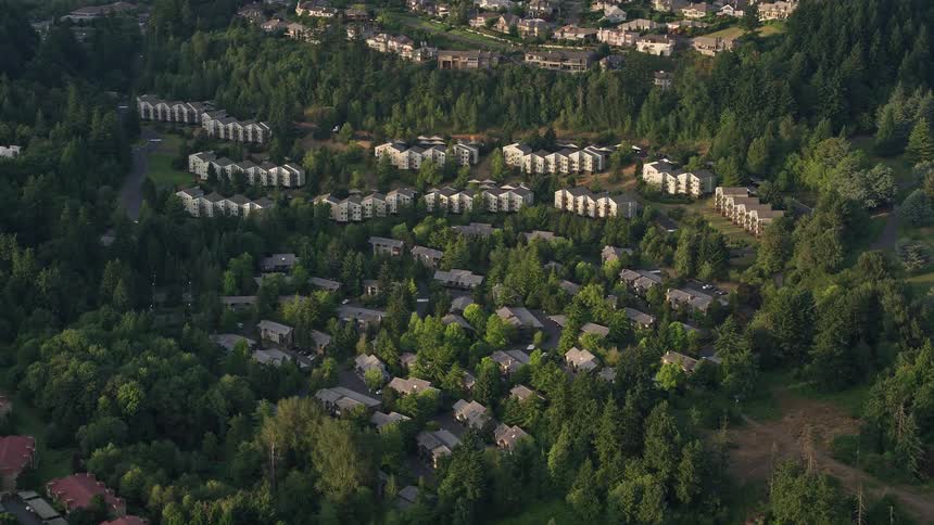 an aerial view of hillside apartment buildings in Southwest Portland Oregon during a vibrant sunset