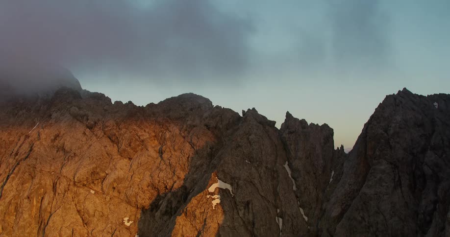 Aerial of a rocky mountain during sunrise