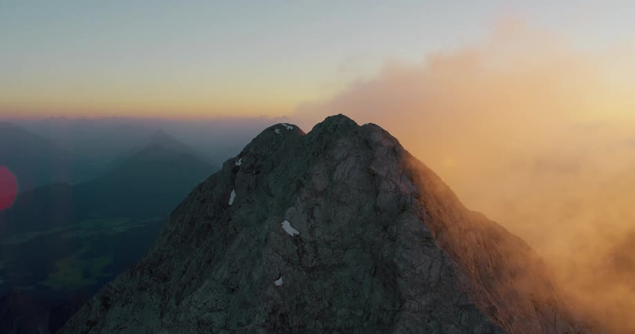 An aerial view of rock mountains and icy mountain peaks