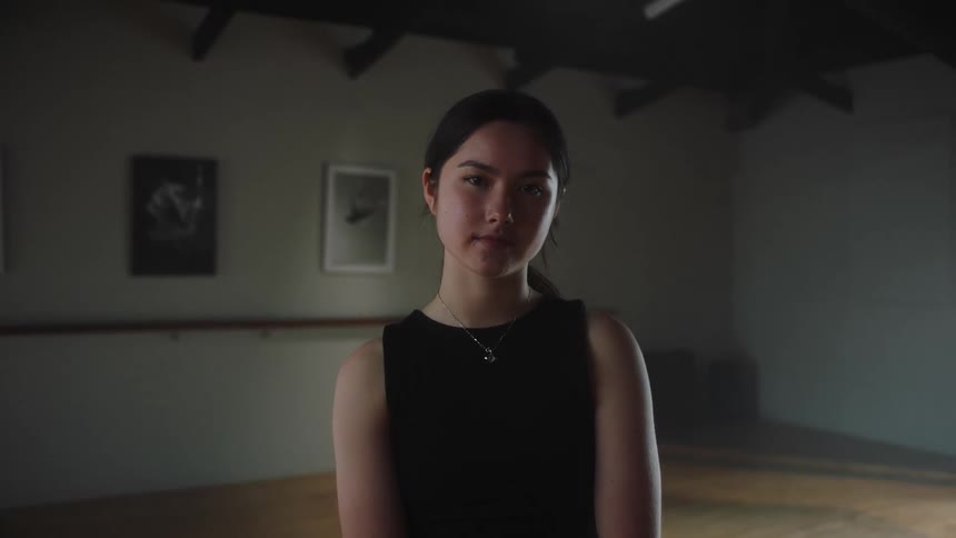 Young woman with a slight smile looking directly at the camera