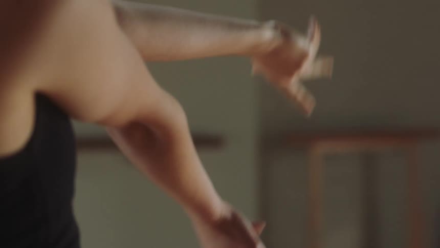 A young woman dancing and gesturing with her arms