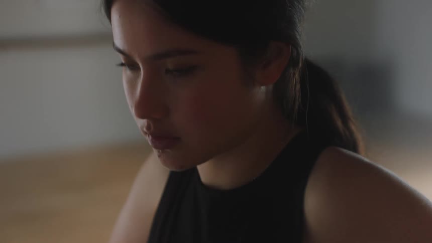 A young woman concentrates before beginning to dance and twirl