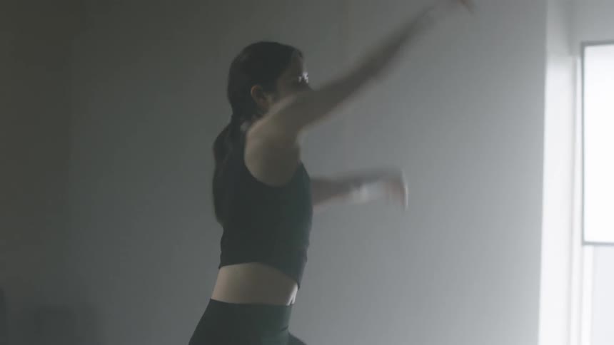 Young woman dancing ballet steps