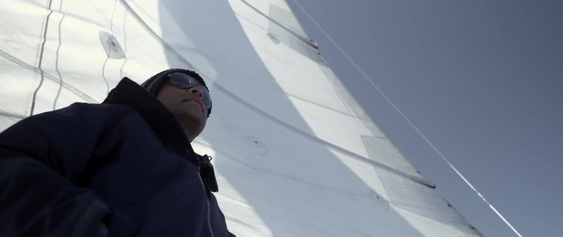 A man is looking off the side of a boat