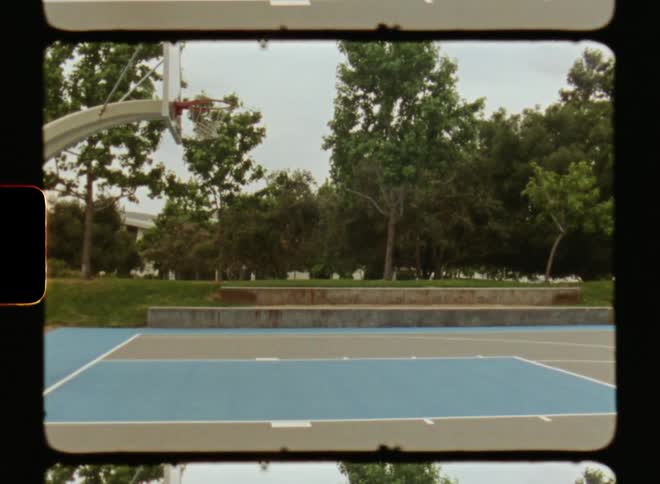 An empty basketball court in an urban neighborhood