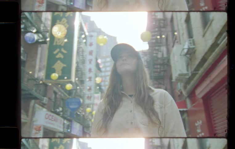 Young woman walking in the middle of an oriental neighborhood with some buildings