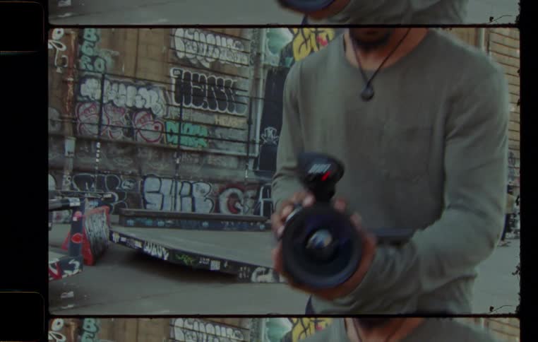 Man holds a video camera on a skate park in the city